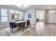 Elegant dining area with a wooden table, blue chairs, and natural light, perfect for gatherings at 17911 N Adobe Mesa Ct, Surprise, AZ 85374