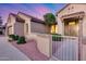 Inviting home entrance with well-manicured landscaping, gated walkway, and modern design at 17911 N Adobe Mesa Ct, Surprise, AZ 85374
