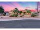 Charming single-story home featuring desert landscaping and a private gated courtyard entrance at 17911 N Adobe Mesa Ct, Surprise, AZ 85374