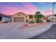 Single-story home featuring desert landscaping, a spacious driveway, and a two car garage at 17911 N Adobe Mesa Ct, Surprise, AZ 85374