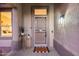 Inviting front entrance with a welcome mat and decorative plants, creating a warm first impression at 17911 N Adobe Mesa Ct, Surprise, AZ 85374
