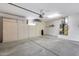 Spacious garage with ample storage cabinets and concrete flooring provides room for vehicles and organization at 17911 N Adobe Mesa Ct, Surprise, AZ 85374