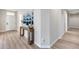 Inviting hallway features wood-look floors and console table with tasteful decorations and blue wall art at 17911 N Adobe Mesa Ct, Surprise, AZ 85374
