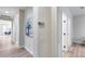 Hallway with wood floors, neutral walls, decorative artwork, and access to various rooms in the home at 17911 N Adobe Mesa Ct, Surprise, AZ 85374