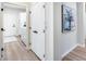 Hallway with doors to the laundry room and closets, and a decorative painting at 17911 N Adobe Mesa Ct, Surprise, AZ 85374