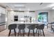 Bright and modern kitchen with stainless appliances, a large island with seating, and stylish pendant lighting at 17911 N Adobe Mesa Ct, Surprise, AZ 85374