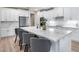 Well-equipped kitchen with an oversized island, modern appliances, ample counter space, and sleek, white cabinetry at 17911 N Adobe Mesa Ct, Surprise, AZ 85374