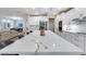 Open-concept kitchen featuring a large island with seating, stainless steel appliances, and an adjacent dining area at 17911 N Adobe Mesa Ct, Surprise, AZ 85374