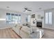Cozy living room with a fireplace, built-in shelving, comfortable sofa, and ample natural light at 17911 N Adobe Mesa Ct, Surprise, AZ 85374
