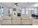 Bright living room featuring a modern fireplace, built-in shelving, and plush, corduroy sofa for comfortable seating at 17911 N Adobe Mesa Ct, Surprise, AZ 85374