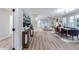 Bright, open-concept living and dining area with wood floors, modern lighting, and stylish furniture at 17911 N Adobe Mesa Ct, Surprise, AZ 85374