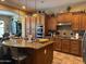 Spacious kitchen with a large island, granite countertops, and wooden cabinets with stainless steel appliances at 18008 W Ocotillo Ave, Goodyear, AZ 85338