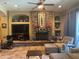 Cozy living room featuring a stone fireplace, built-in shelving, tile floors, and comfortable furniture at 18008 W Ocotillo Ave, Goodyear, AZ 85338