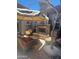 Cozy outdoor patio with a stone fireplace, wicker seating, shade umbrella, and tranquil ambiance at 18008 W Ocotillo Ave, Goodyear, AZ 85338