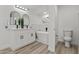 A well-lit bathroom showcasing a soaking tub, dual vanity, and sleek finishes at 2106 W 8Th Ave, Mesa, AZ 85202