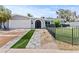Charming single-story home featuring an attached garage and manicured front yard with fresh turf accents at 2106 W 8Th Ave, Mesa, AZ 85202