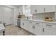 Modern kitchen featuring sleek white cabinets, stainless steel appliances, and a contemporary backsplash at 2106 W 8Th Ave, Mesa, AZ 85202