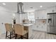 Bright kitchen featuring white cabinets, stainless steel appliances, and a stylish tile backsplash at 2106 W 8Th Ave, Mesa, AZ 85202