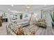 Bright living room featuring light wood floors, contemporary furnishings, and large windows at 2106 W 8Th Ave, Mesa, AZ 85202