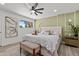 A luxurious main bedroom is decorated with an accent wall, tray, and comfortable furnishings at 2106 W 8Th Ave, Mesa, AZ 85202