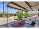 Relaxing covered patio with comfortable seating, an outdoor BBQ area and a decorative outdoor rug at 2118 W Cactus Wren Dr, Phoenix, AZ 85021