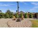 Charming backyard fire pit and seating area, surrounded by privacy landscaping and rock ground cover at 2118 W Cactus Wren Dr, Phoenix, AZ 85021