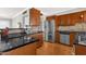 Contemporary kitchen featuring stainless appliances, dark countertops and wooden cabinetry at 2118 W Cactus Wren Dr, Phoenix, AZ 85021