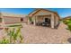 Serene backyard with a covered patio, well-maintained gravel landscaping, and an outdoor dining area at 22403 W Harrison St, Buckeye, AZ 85326