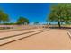 Outdoor bocce ball court with benches and landscaped surroundings on a sunny day at 22403 W Harrison St, Buckeye, AZ 85326