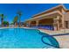 Resort-style community pool area with lounge chairs, a covered pavilion, and inviting blue water at 22403 W Harrison St, Buckeye, AZ 85326