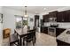 Dining area featuring a wooden table, seating for six, and access to the outdoor patio at 22403 W Harrison St, Buckeye, AZ 85326