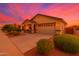 Charming single-story home featuring a two-car garage, landscaped yard, and inviting covered porch at 22403 W Harrison St, Buckeye, AZ 85326