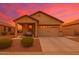 Inviting single-story home showcasing a covered porch, easy care landscaping, and a two-car garage at 22403 W Harrison St, Buckeye, AZ 85326