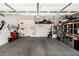 Spacious garage with ample storage solutions and overhead racks, perfect for organization at 22403 W Harrison St, Buckeye, AZ 85326