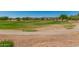 Scenic view of the community golf course with lush green fairways and mature trees at 22403 W Harrison St, Buckeye, AZ 85326