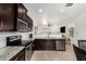 Modern kitchen equipped with stainless steel appliances, granite countertops, and white tile backsplash at 22403 W Harrison St, Buckeye, AZ 85326