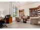 Cozy library with built-in bookshelves, comfortable seating, and natural light, perfect for reading at 22403 W Harrison St, Buckeye, AZ 85326