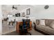 Cozy living room showcasing a comfortable sofa, ceiling fan, and seamless transition to the kitchen at 22403 W Harrison St, Buckeye, AZ 85326