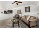 Well-lit living room showcasing an open floorplan, neutral tones, ceiling fan, and comfortable seating at 22403 W Harrison St, Buckeye, AZ 85326