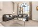 Comfortable living room with stylish sofas, a large window, and elegant décor at 22403 W Harrison St, Buckeye, AZ 85326