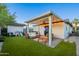Backyard with a covered patio area, lounge seating, picnic table and artificial turf at 2520 N 15Th St, Phoenix, AZ 85006