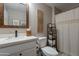 Neutral bathroom featuring a vanity, decorative mirror, wooden accents and shower with curtain at 2520 N 15Th St, Phoenix, AZ 85006