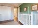 Bedroom area featuring a modern white crib, green accent wall and a view into the bathroom at 2520 N 15Th St, Phoenix, AZ 85006
