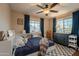 Comfortable bedroom featuring a large window, ceiling fan, and built-in shelving at 2520 N 15Th St, Phoenix, AZ 85006