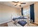 Comfortable bedroom featuring a large window, ceiling fan, and built-in shelving at 2520 N 15Th St, Phoenix, AZ 85006
