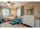 Inviting bedroom with a cozy chair, a green nugget couch, dresser, mirror and natural light at 2520 N 15Th St, Phoenix, AZ 85006