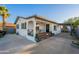 Charming home exterior with a cozy front porch, seating, and well-maintained landscaping at 2520 N 15Th St, Phoenix, AZ 85006