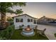 Charming home showcasing a cozy fire pit with Adirondack chairs on artificial grass at 2520 N 15Th St, Phoenix, AZ 85006