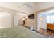 Bright main bedroom with a ceiling fan, access to a bathroom, and ample natural light at 2520 N 15Th St, Phoenix, AZ 85006