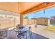 Charming backyard patio with a seating area, barbecue, fire pit, shed and plenty of room for relaxation at 25519 W Crown King Rd, Buckeye, AZ 85326